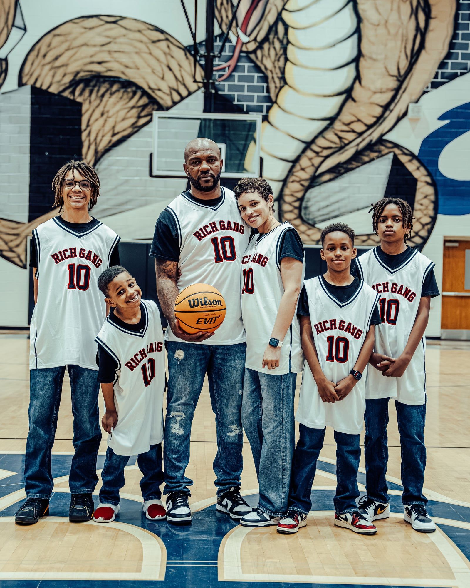 Mary Richardson and her family in matching basketball jerseys on a gym court