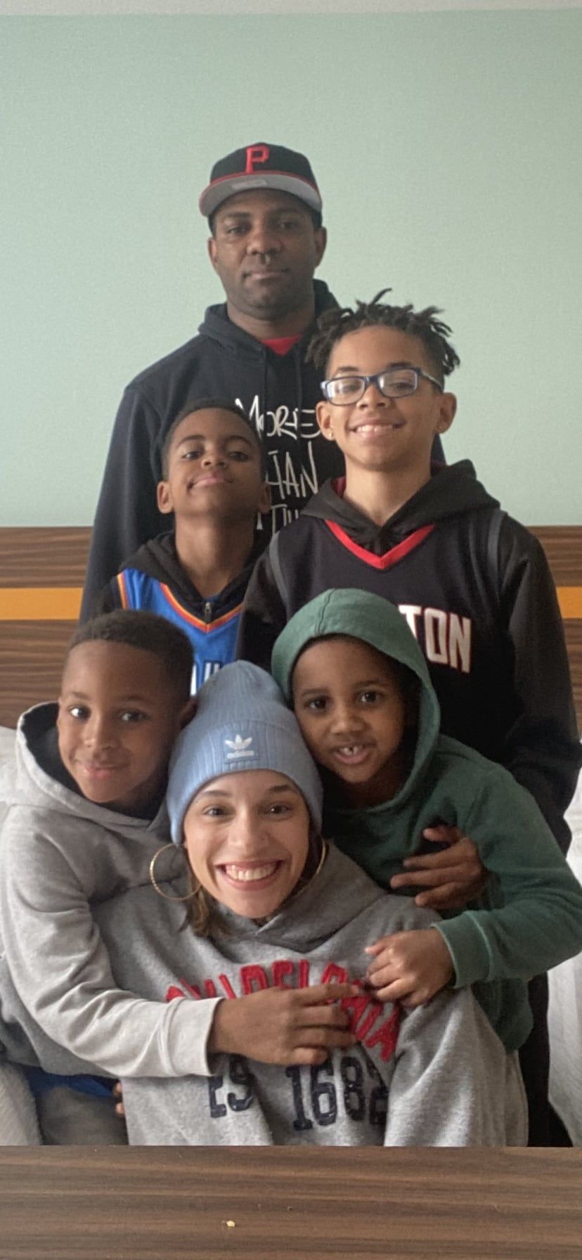 Mary Richardson smiling with her family, all bundled up in hoodies