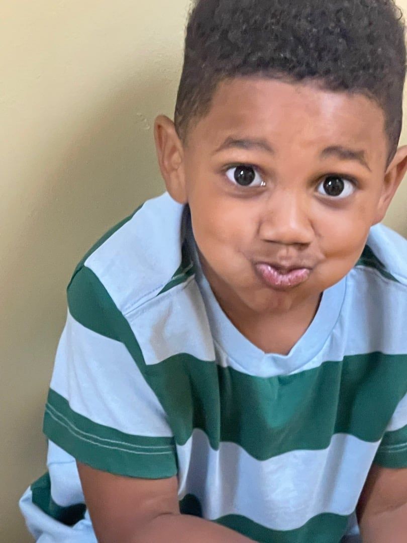 A boy puffing out his cheeks for a silly photo
